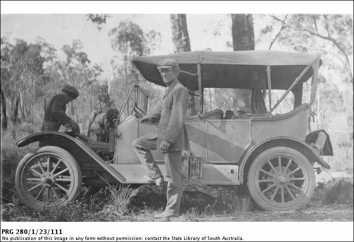 PRG280_1_23_111_Men_working_on_engine